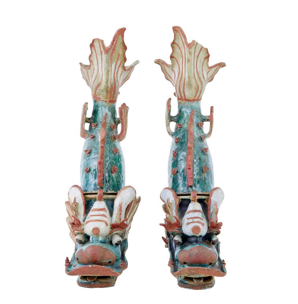 A pair of 19th-century Japanese glazed ceramic Shachihoko roof ornaments depicting dragon-headed carp with raised tails in green, red, and cream glazes. View IV