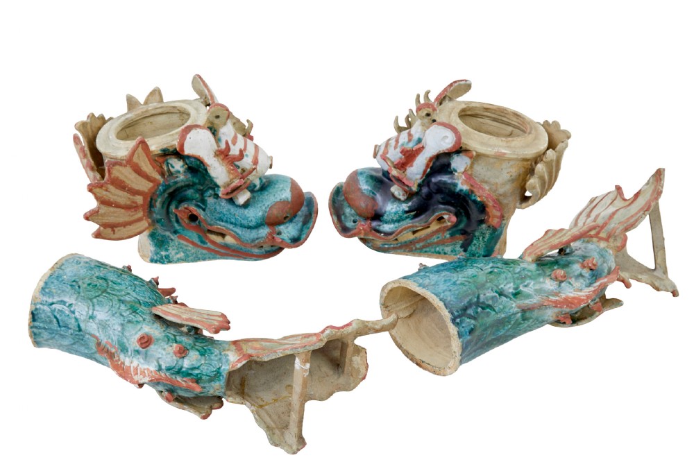 A pair of 19th-century Japanese glazed ceramic Shachihoko roof ornaments depicting dragon-headed carp with raised tails in green, red, and cream glazes. View X