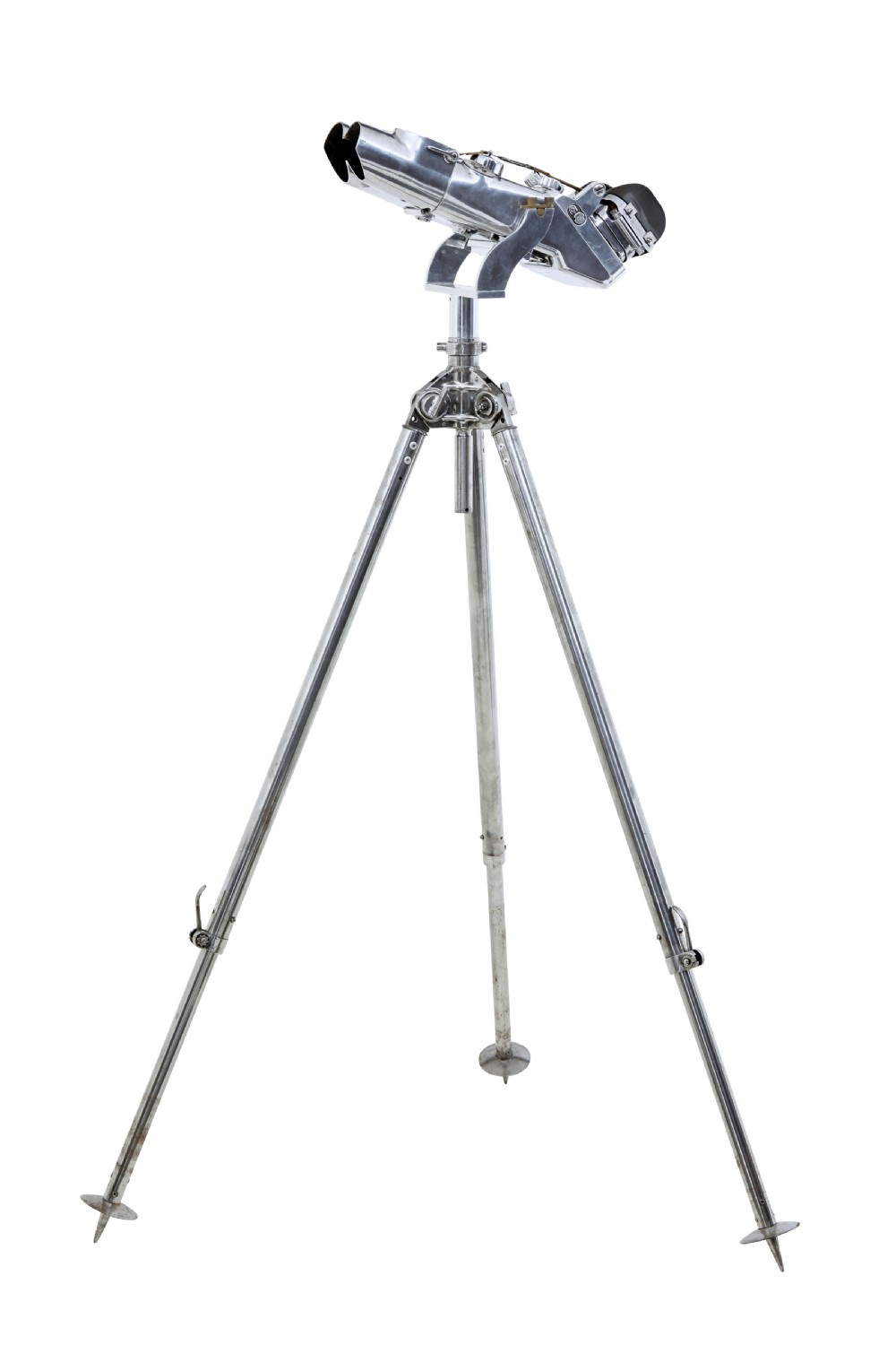 A pair of polished steel military binoculars mounted on a tall three-legged metal tripod stand against a plain background.