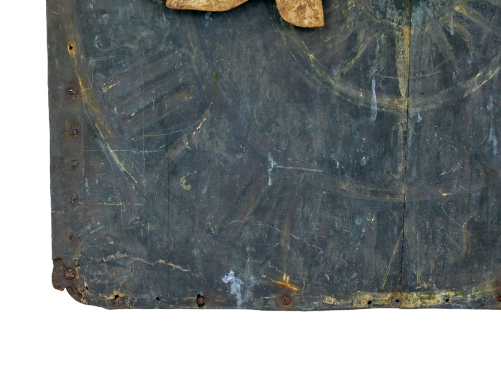 A square 18th-century Swedish copper turret clock face featuring a green verdigris patina, central sunburst motif, Roman numerals, and a single hand shaped like a pointer. View III