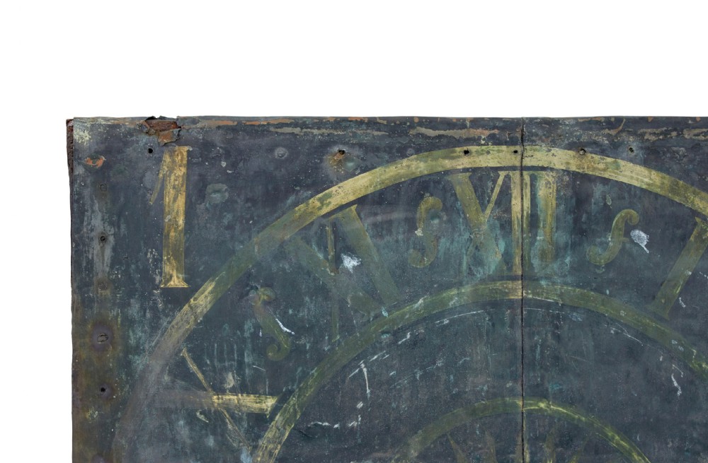 A square 18th-century Swedish copper turret clock face featuring a green verdigris patina, central sunburst motif, Roman numerals, and a single hand shaped like a pointer. View IV