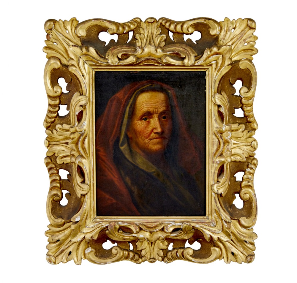 An 18th-century oil portrait depicting an elderly woman with a red hood, housed in a heavily carved gold gilt frame.