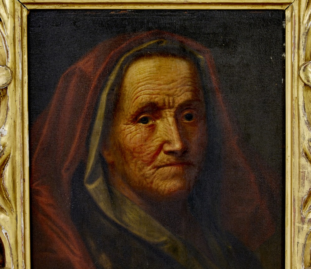 An 18th-century oil portrait depicting an elderly woman with a red hood, housed in a heavily carved gold gilt frame. View III