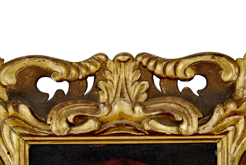 An 18th-century oil portrait depicting an elderly woman with a red hood, housed in a heavily carved gold gilt frame. View V