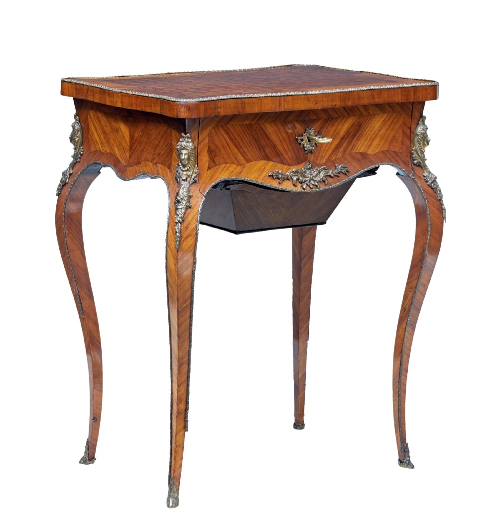 A 19th-century French kingwood sewing work table featuring parquetry veneering, cabriole legs, gilt-bronze mounts, and a lower fabric-lined storage bin.