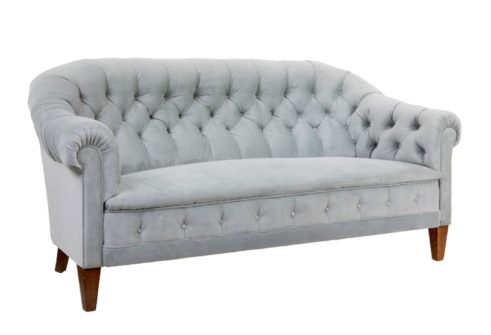 An early 20th-century three-piece suite comprising a two-seater sofa and two matching armchairs upholstered in light grey deep-buttoned velvet with tapered wooden legs. View III