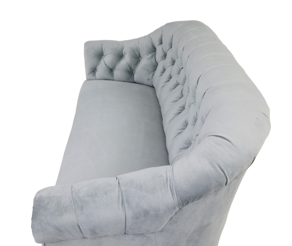 An early 20th-century three-piece suite comprising a two-seater sofa and two matching armchairs upholstered in light grey deep-buttoned velvet with tapered wooden legs. View VII