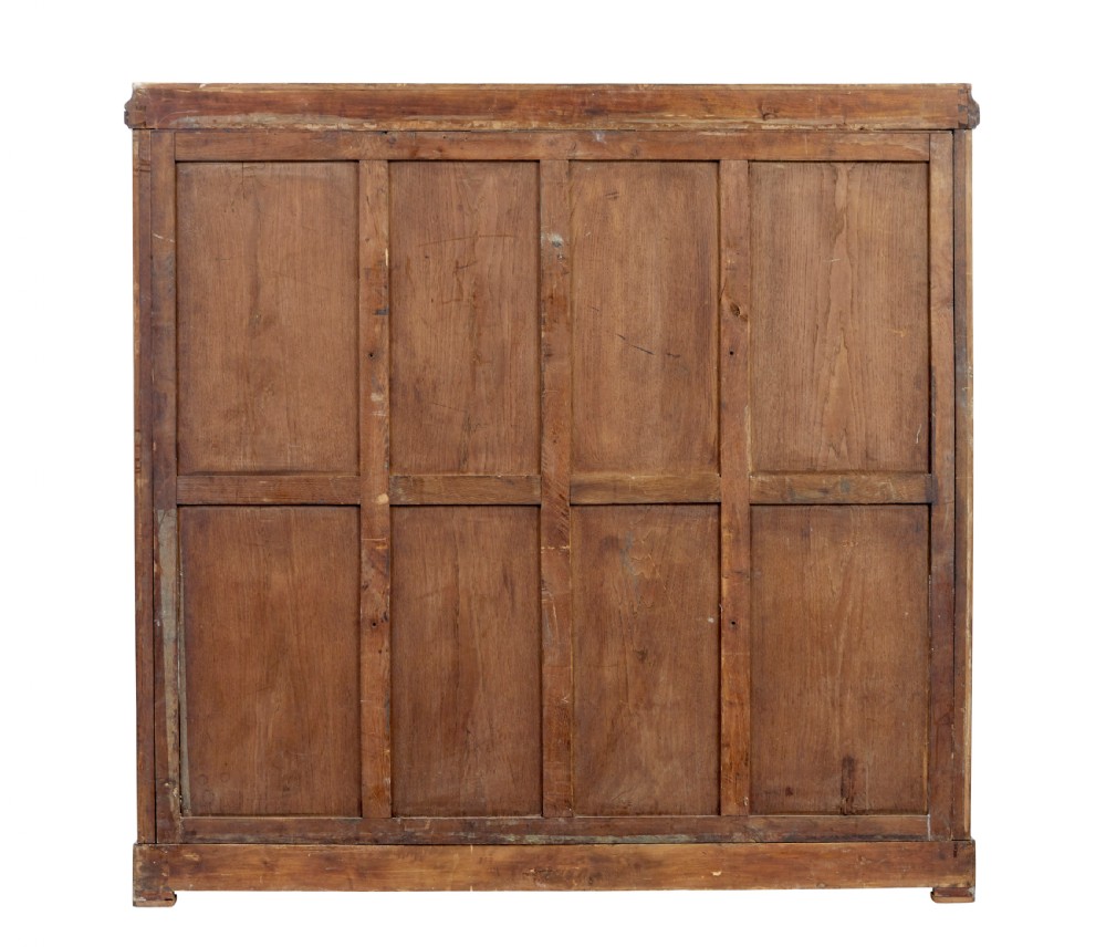 A nineteenth-century French Empire style mahogany cabinet featuring decorative ormolu mounts, a central brass wire mesh door, and outer panelled doors with shell inlays. View V