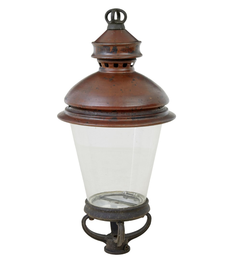 A 19th-century French copper street lantern featuring a conical copper roof with a crown finial and a tapered clear glass shade above a dark metal base.