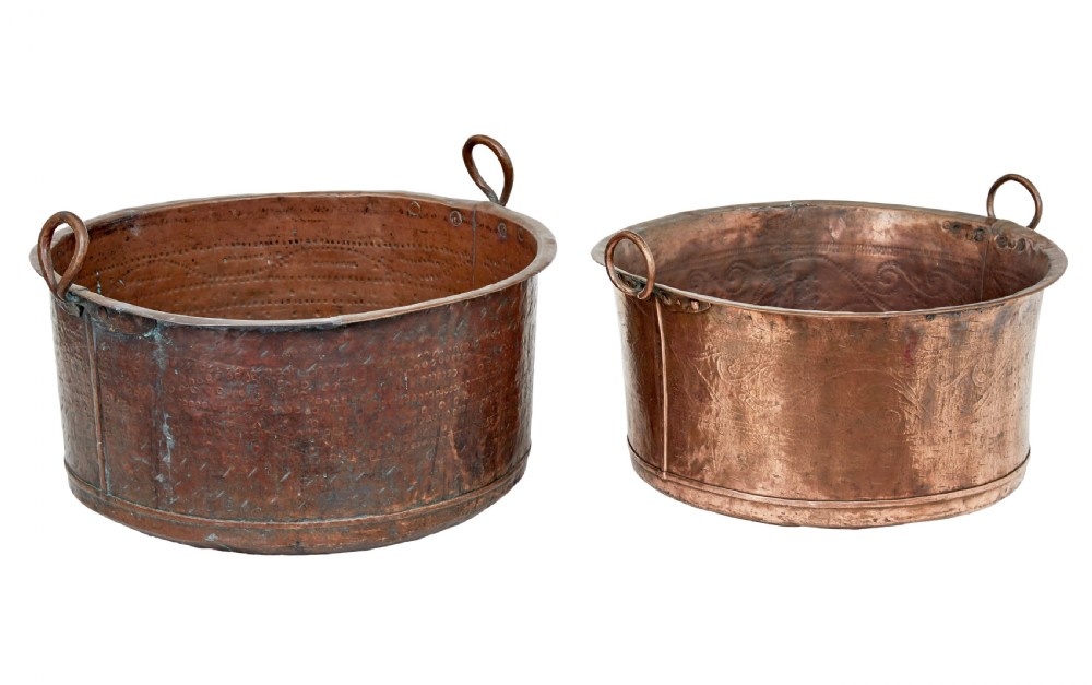 A pair of nineteenth-century hand-hammered copper cooking vessels featuring rolled rims, loop side handles, and chased decorative patterns around the bodies. View III