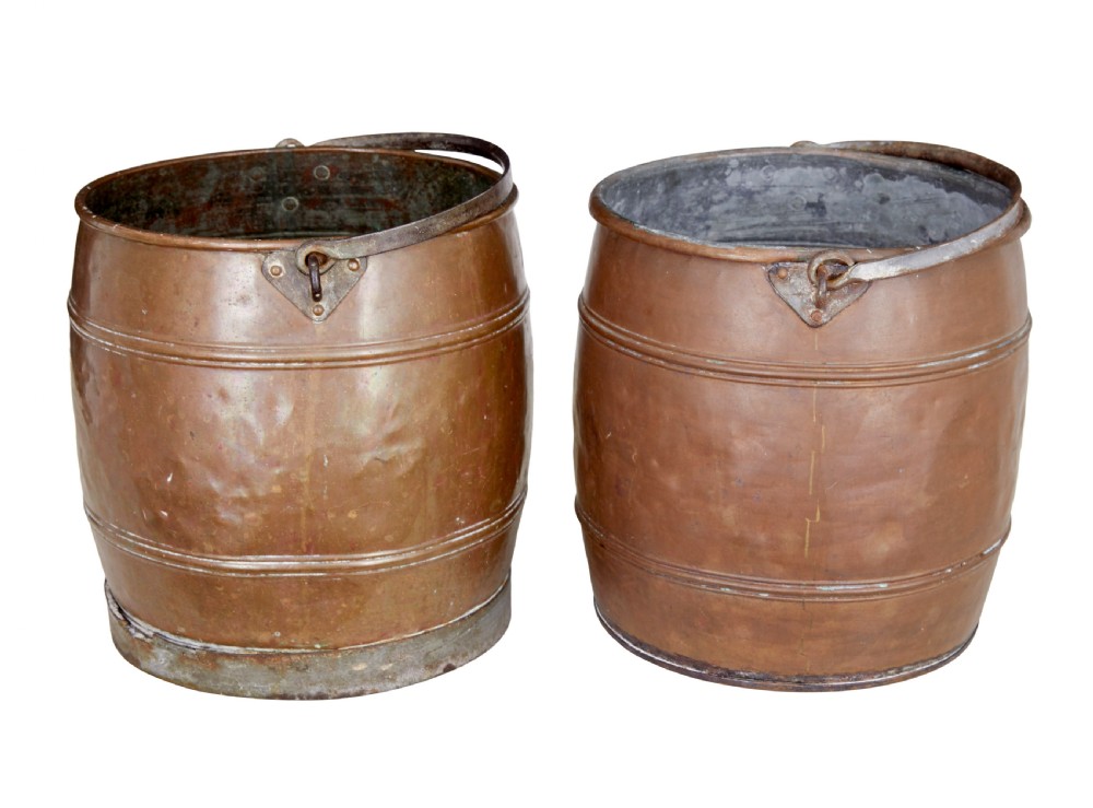 A near pair of late 19th-century cylindrical copper buckets featuring hand-hammered surfaces, reeded metal bands, and dark iron swing handles. View II