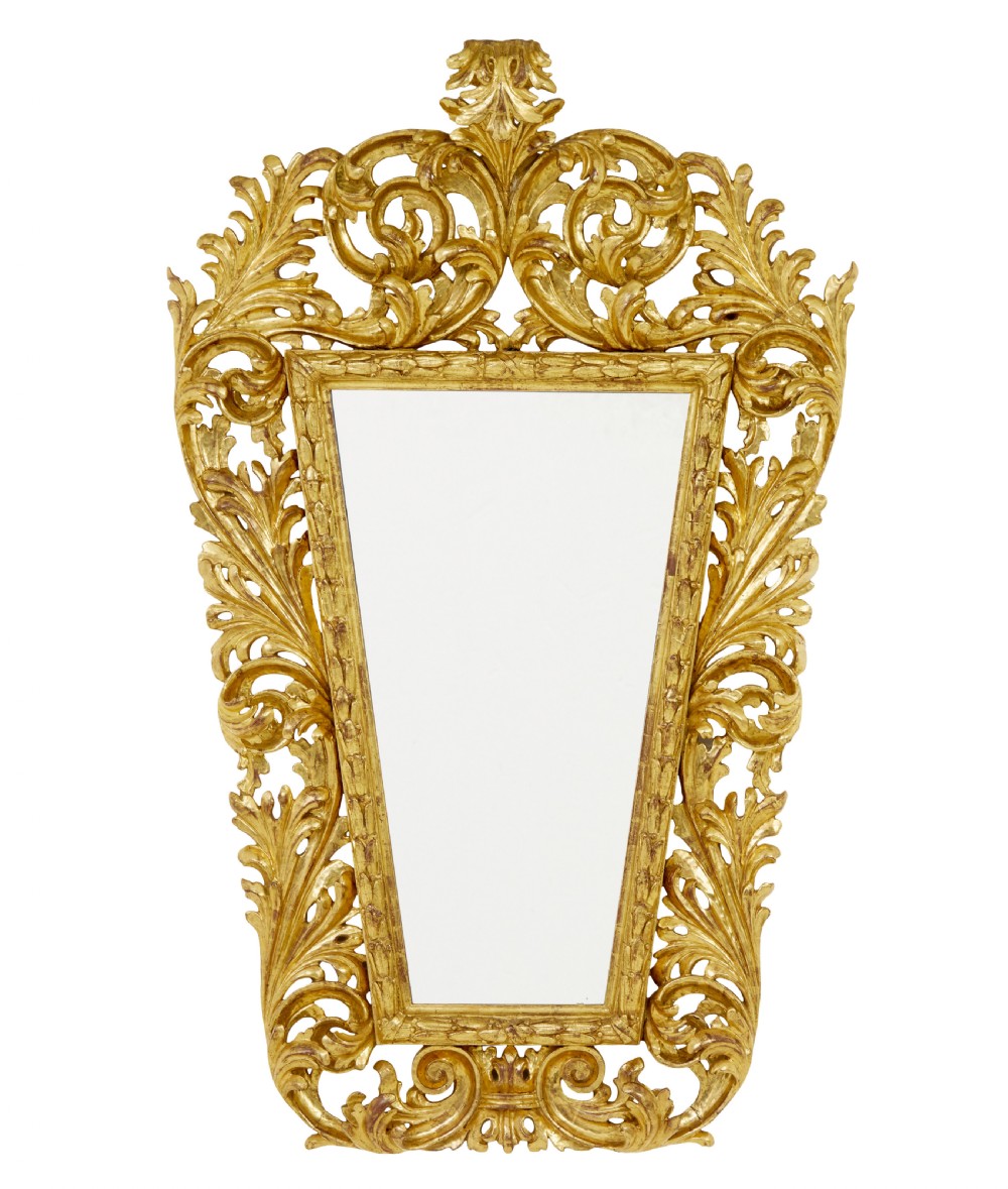 An 18th-century Italian Rococo wall mirror featuring an openwork carved giltwood frame decorated with acanthus leaf scrolls and a decorative cresting around a glass plate.