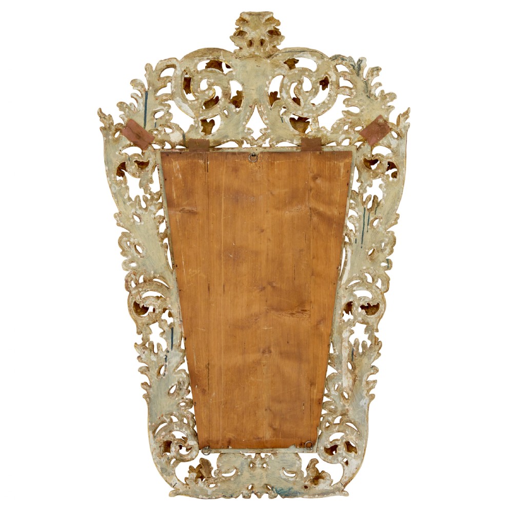 An 18th-century Italian Rococo wall mirror featuring an openwork carved giltwood frame decorated with acanthus leaf scrolls and a decorative cresting around a glass plate. View VIII