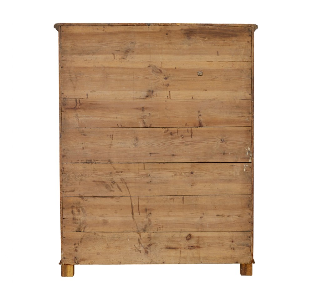 A 19th-century Swedish pine cupboard featuring two panelled doors with a warm amber rag-painted finish and scalloped moulding detailing. View X