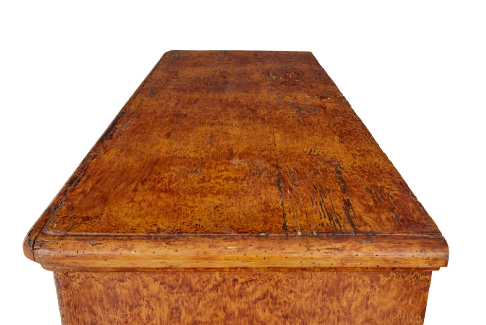 A 19th-century Swedish pine cupboard featuring two panelled doors with a warm amber rag-painted finish and scalloped moulding detailing. View XI