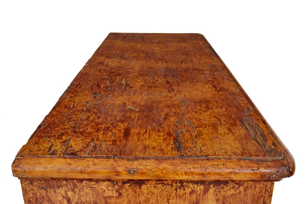 A 19th-century Swedish pine cupboard featuring two panelled doors with a warm amber rag-painted finish and scalloped moulding detailing. View XII