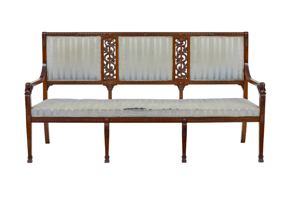 An early twentieth-century seven-piece Empire Revival walnut salon suite comprising a bench, two armchairs, and four side chairs with carved serpent back splats. View II