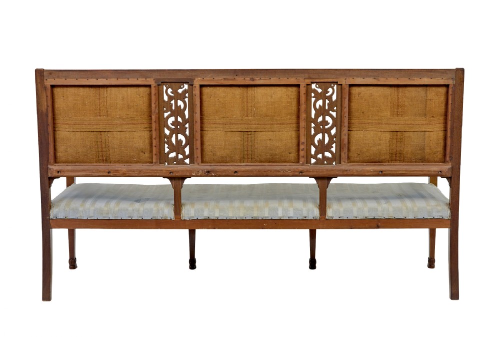 An early twentieth-century seven-piece Empire Revival walnut salon suite comprising a bench, two armchairs, and four side chairs with carved serpent back splats. View IV