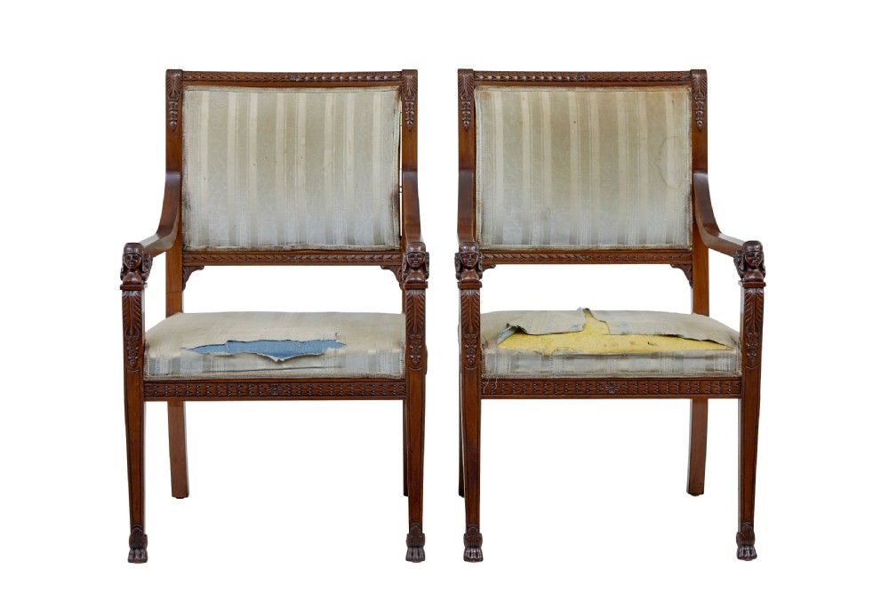 An early twentieth-century seven-piece Empire Revival walnut salon suite comprising a bench, two armchairs, and four side chairs with carved serpent back splats. View V