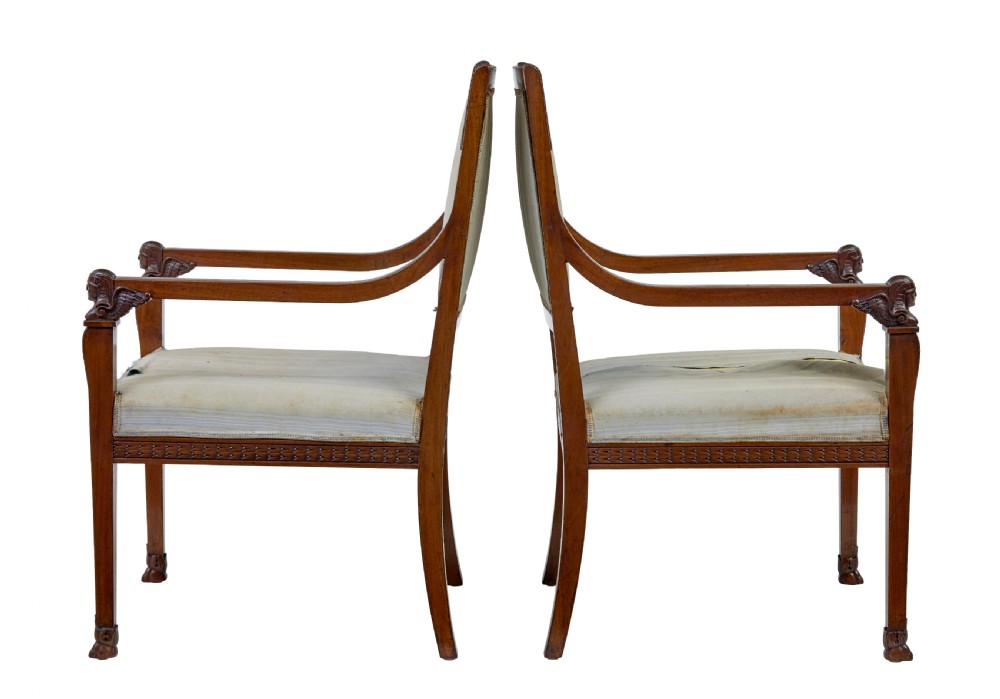 An early twentieth-century seven-piece Empire Revival walnut salon suite comprising a bench, two armchairs, and four side chairs with carved serpent back splats. View VI