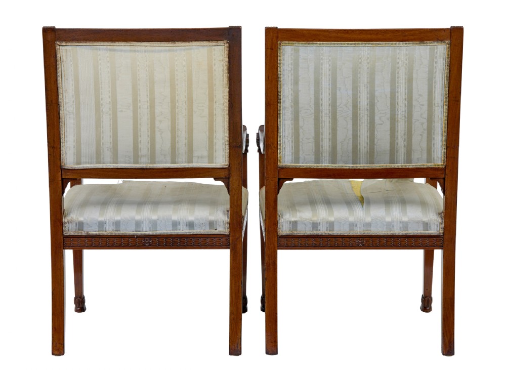 An early twentieth-century seven-piece Empire Revival walnut salon suite comprising a bench, two armchairs, and four side chairs with carved serpent back splats. View VII