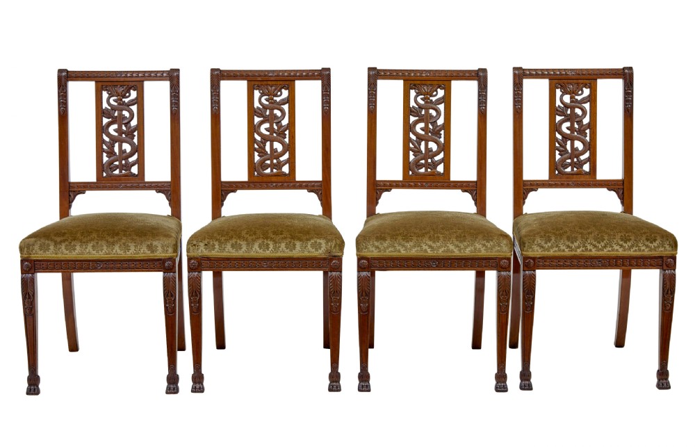 An early twentieth-century seven-piece Empire Revival walnut salon suite comprising a bench, two armchairs, and four side chairs with carved serpent back splats. View X