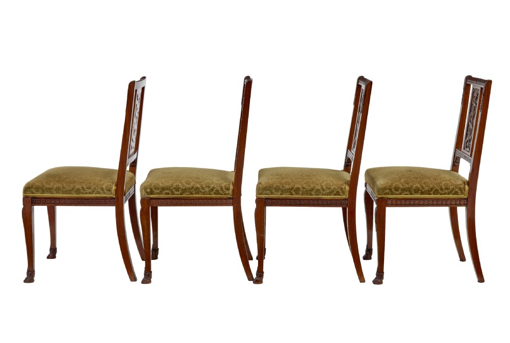 An early twentieth-century seven-piece Empire Revival walnut salon suite comprising a bench, two armchairs, and four side chairs with carved serpent back splats. View XI
