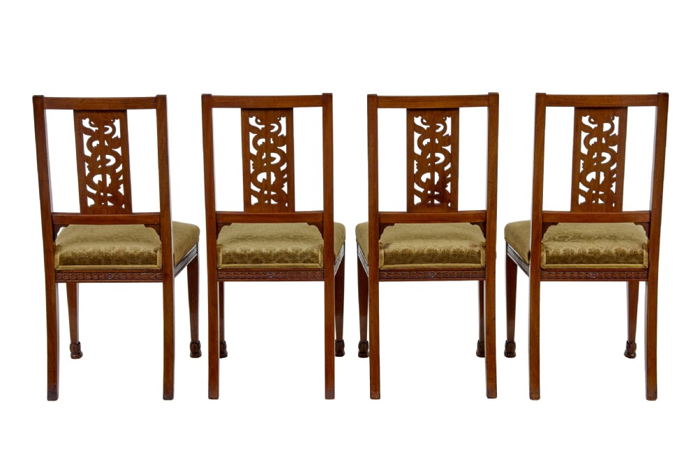 An early twentieth-century seven-piece Empire Revival walnut salon suite comprising a bench, two armchairs, and four side chairs with carved serpent back splats. View XII