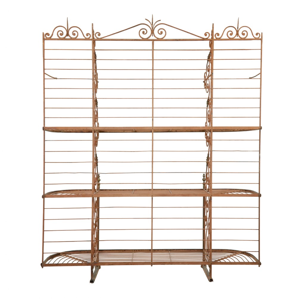 An early 20th-century French wrought iron and brass bakers rack featuring decorative scrollwork and three open slatted shelves. View IV