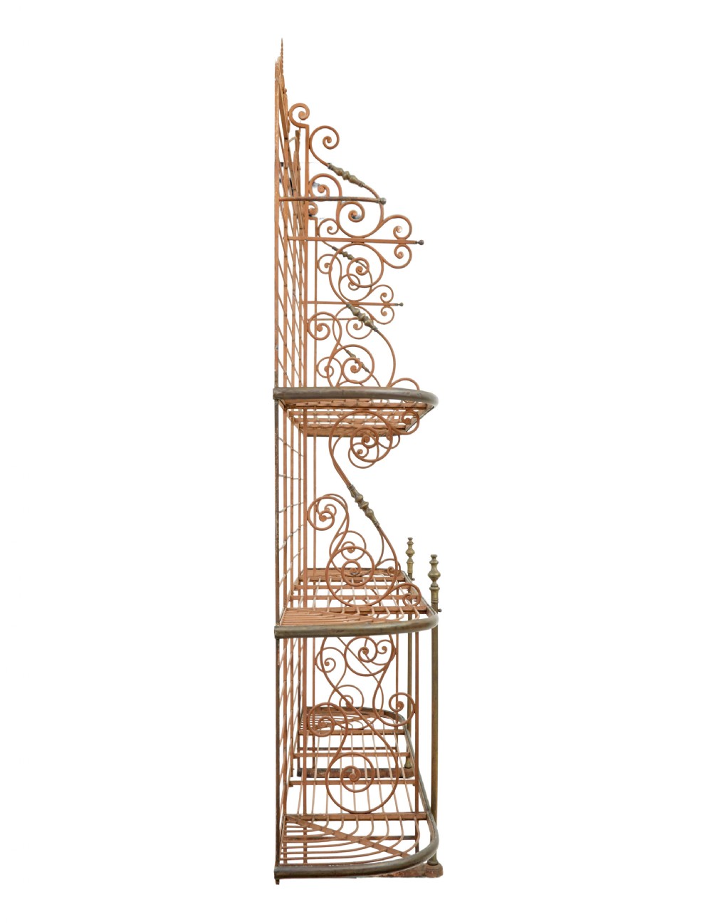 An early 20th-century French wrought iron and brass bakers rack featuring decorative scrollwork and three open slatted shelves. View V