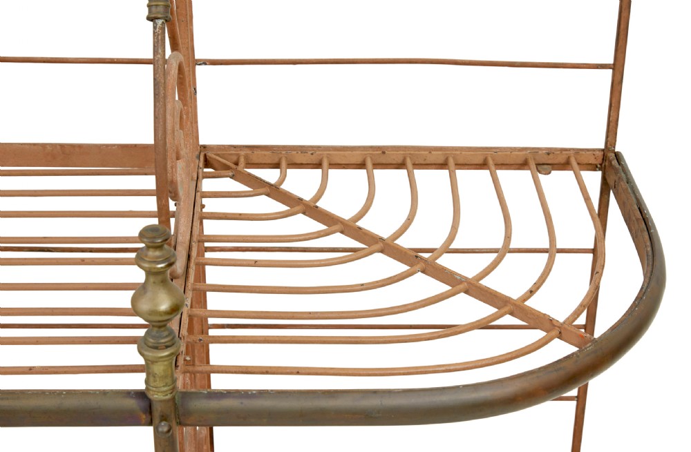 An early 20th-century French wrought iron and brass bakers rack featuring decorative scrollwork and three open slatted shelves. View IX