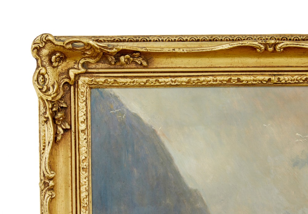 A 19th-century framed oil painting depicting three women gathering shellfish along a rocky, wave-swept coastline set within an ornate gilded frame. View V