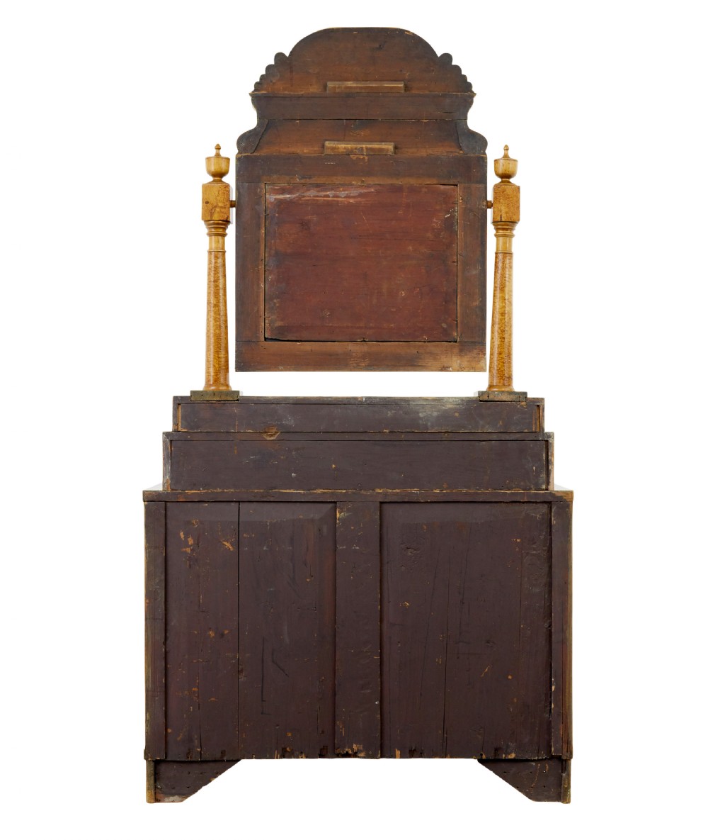 An early 19th-century Biedermeier vanity cabinet featuring a central framed mirror, stepped tier of small drawers, and a double-door base in figured golden birch timber. View VI