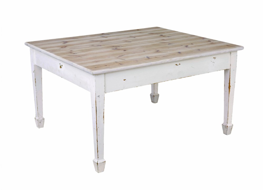 A large square Swedish nineteenth-century kitchen table featuring a natural scrubbed pine plank top and a white painted frame with square tapered legs.