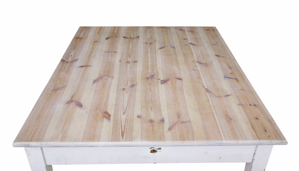 A large square Swedish nineteenth-century kitchen table featuring a natural scrubbed pine plank top and a white painted frame with square tapered legs. View V