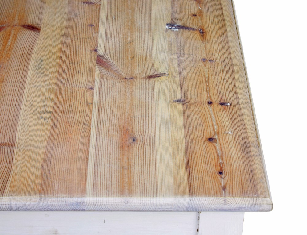 A large square Swedish nineteenth-century kitchen table featuring a natural scrubbed pine plank top and a white painted frame with square tapered legs. View VI