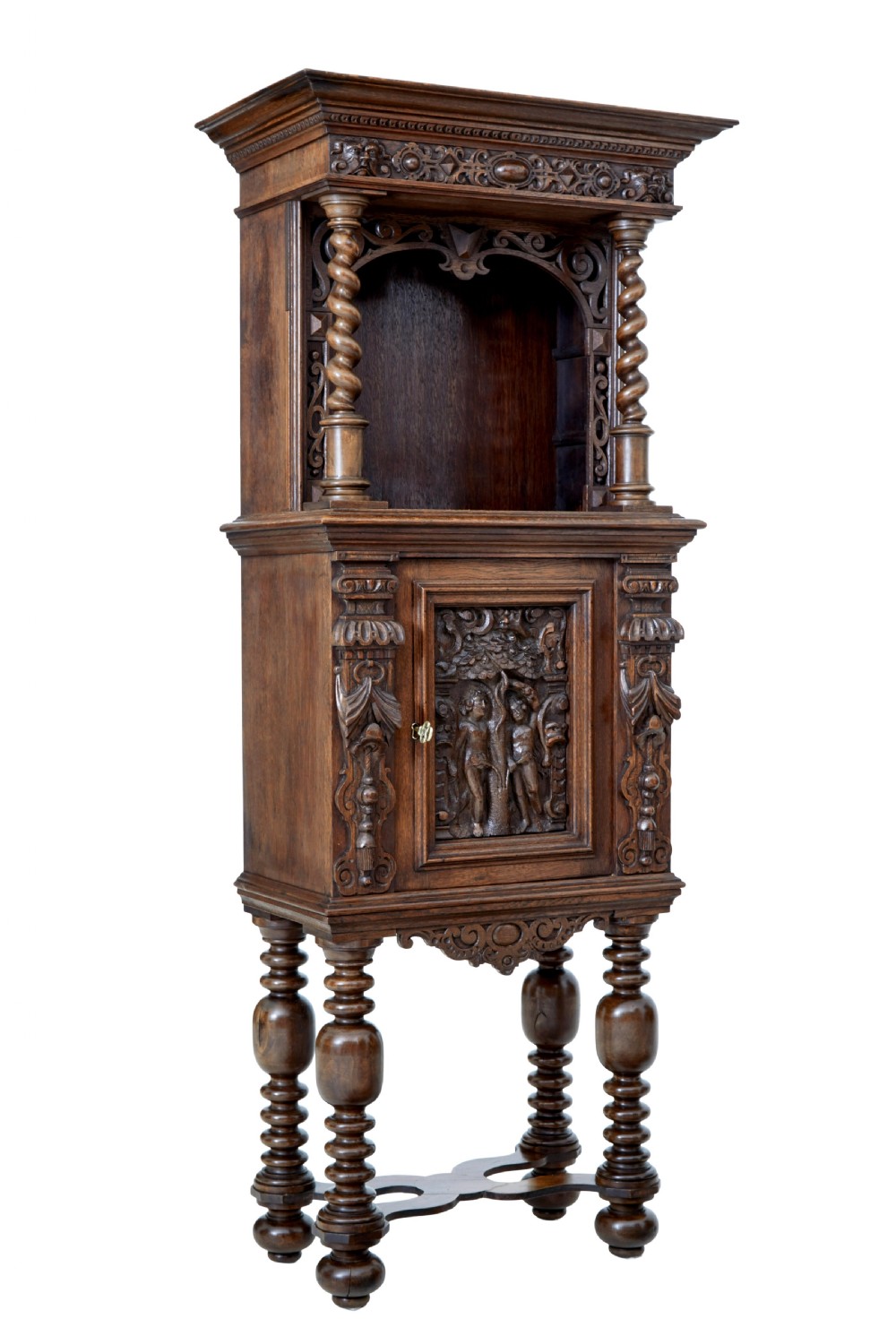 A nineteenth-century Flemish carved oak hall cupboard featuring an upper open niche framed by spiral columns above a single relief-carved door mounted on turned legs.