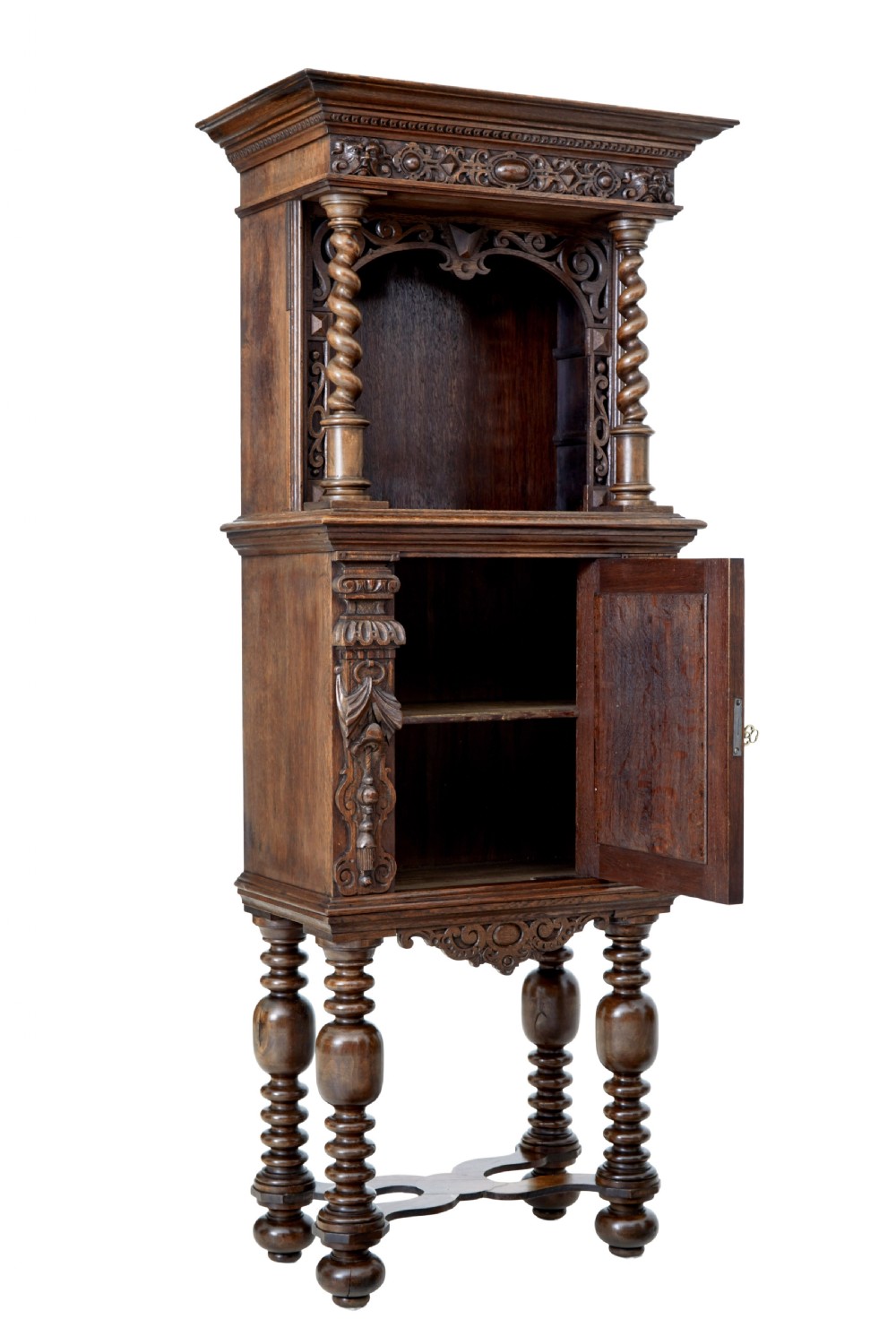 A nineteenth-century Flemish carved oak hall cupboard featuring an upper open niche framed by spiral columns above a single relief-carved door mounted on turned legs. View II