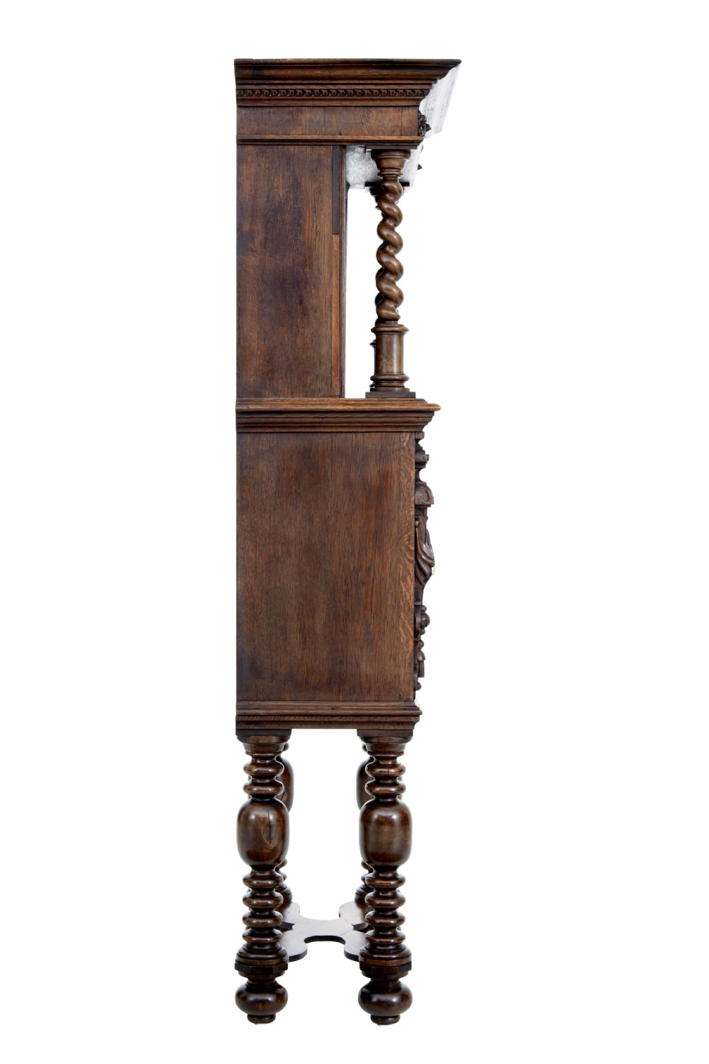 A nineteenth-century Flemish carved oak hall cupboard featuring an upper open niche framed by spiral columns above a single relief-carved door mounted on turned legs. View IV
