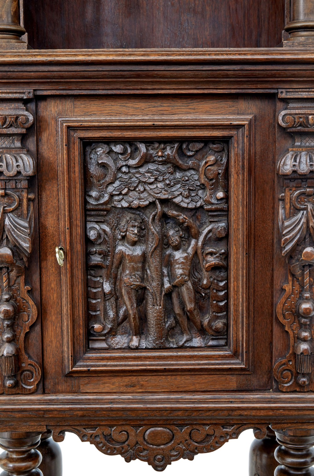 A nineteenth-century Flemish carved oak hall cupboard featuring an upper open niche framed by spiral columns above a single relief-carved door mounted on turned legs. View VII