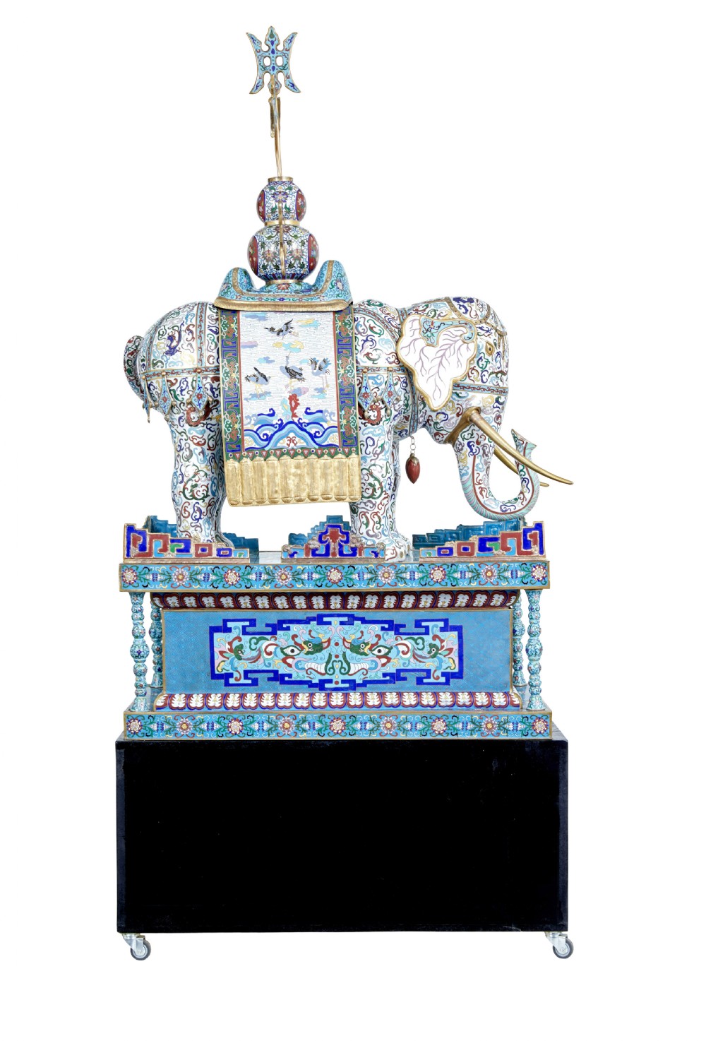An ornate Chinese cloisonne enamel elephant sculpture with a decorated saddle blanket, standing atop a matching enamel pedestal base. View V