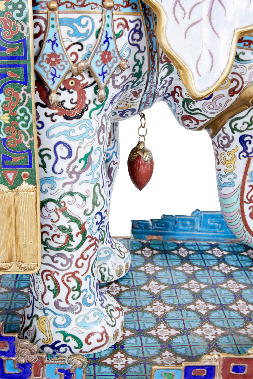 An ornate Chinese cloisonne enamel elephant sculpture with a decorated saddle blanket, standing atop a matching enamel pedestal base. View VIII
