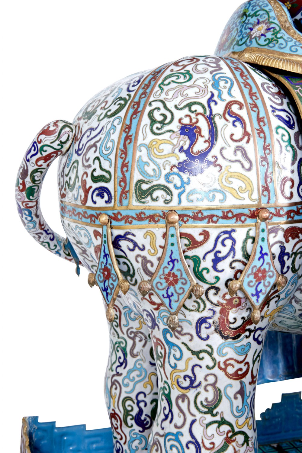 An ornate Chinese cloisonne enamel elephant sculpture with a decorated saddle blanket, standing atop a matching enamel pedestal base. View IX