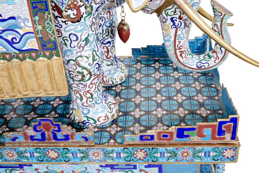 An ornate Chinese cloisonne enamel elephant sculpture with a decorated saddle blanket, standing atop a matching enamel pedestal base. View XII