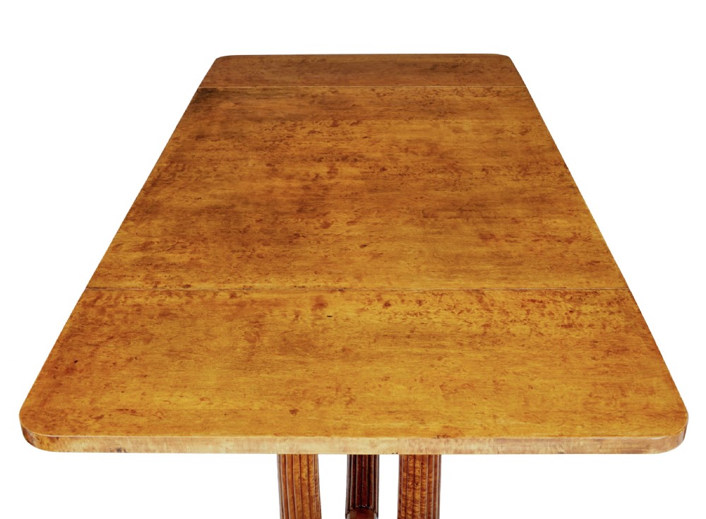 A nineteenth-century Biedermeier burr birch sofa table featuring twin drop leaves, a frieze drawer, fluted column supports, a turned central stretcher, and carved paw feet on castors. View VIII