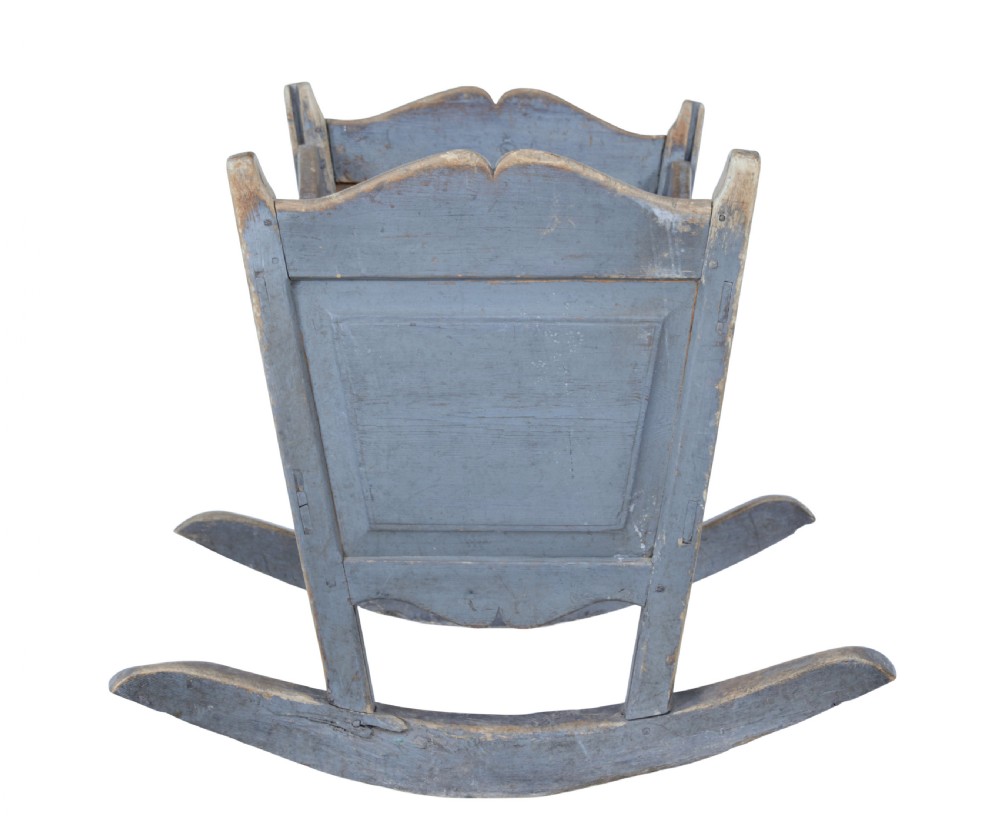 A mid 19th century Swedish pine rocking cradle featuring distressed blue paint and carved wooden ends mounted on twin rockers. View III