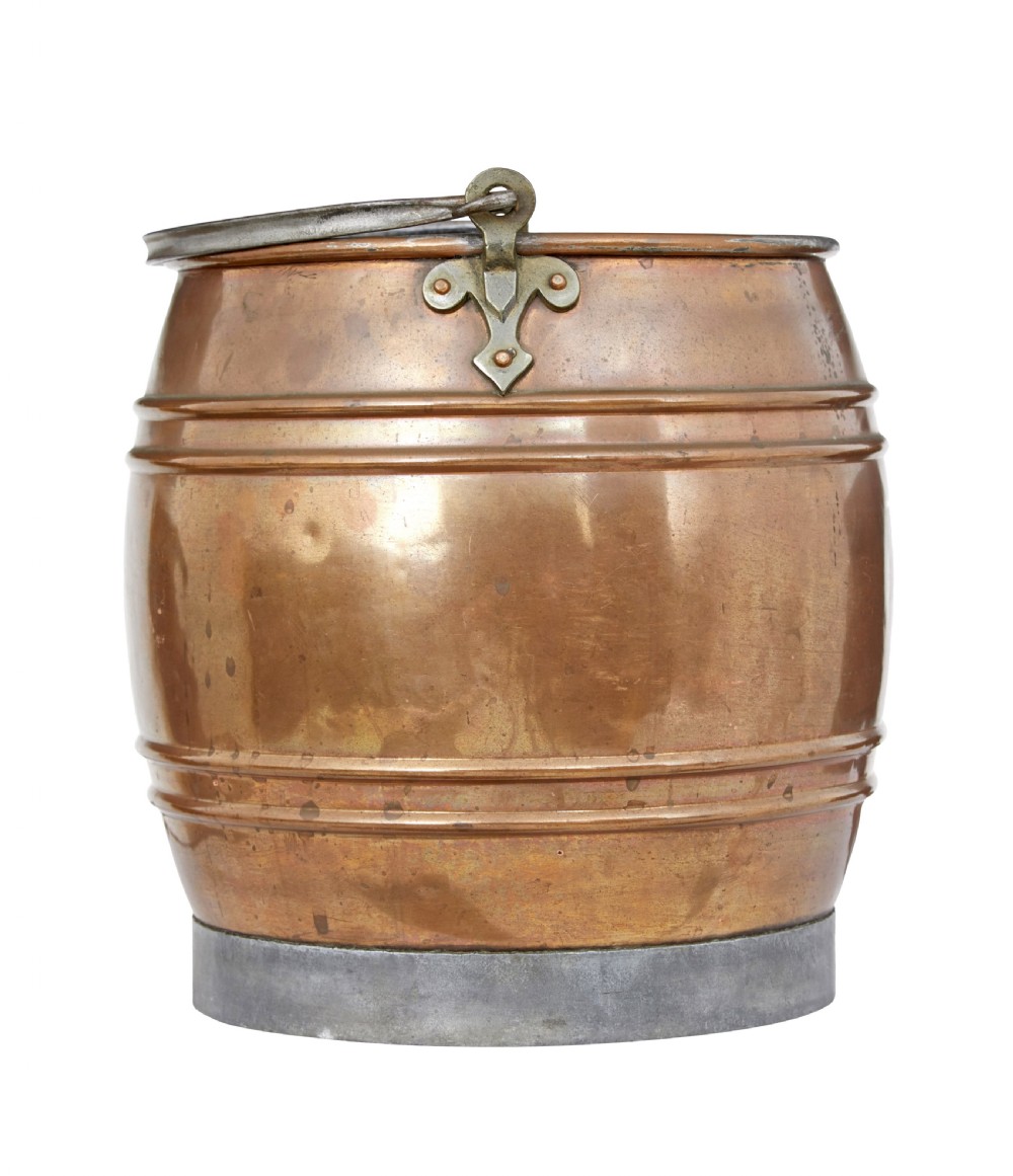 An antique late 19th-century Arts and Crafts copper bucket featuring ribbed barrel detailing, cast metal handle mounts, and an aged finish.