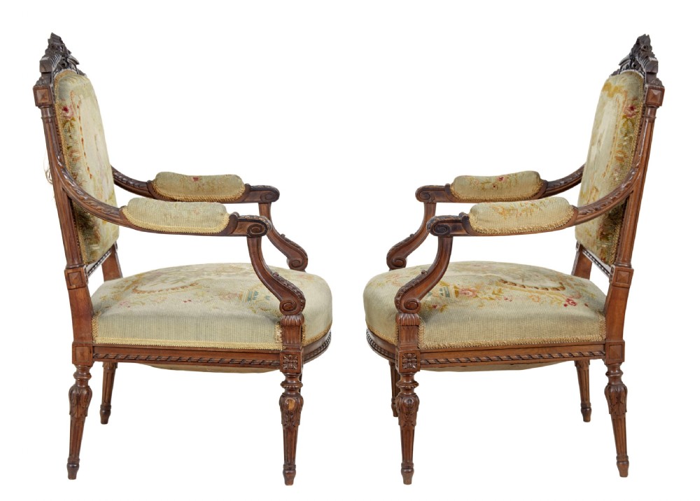 A pair of 19th-century French carved walnut armchairs upholstered in woven tapestry fabric featuring pastoral scenes and fluted turned legs. View III