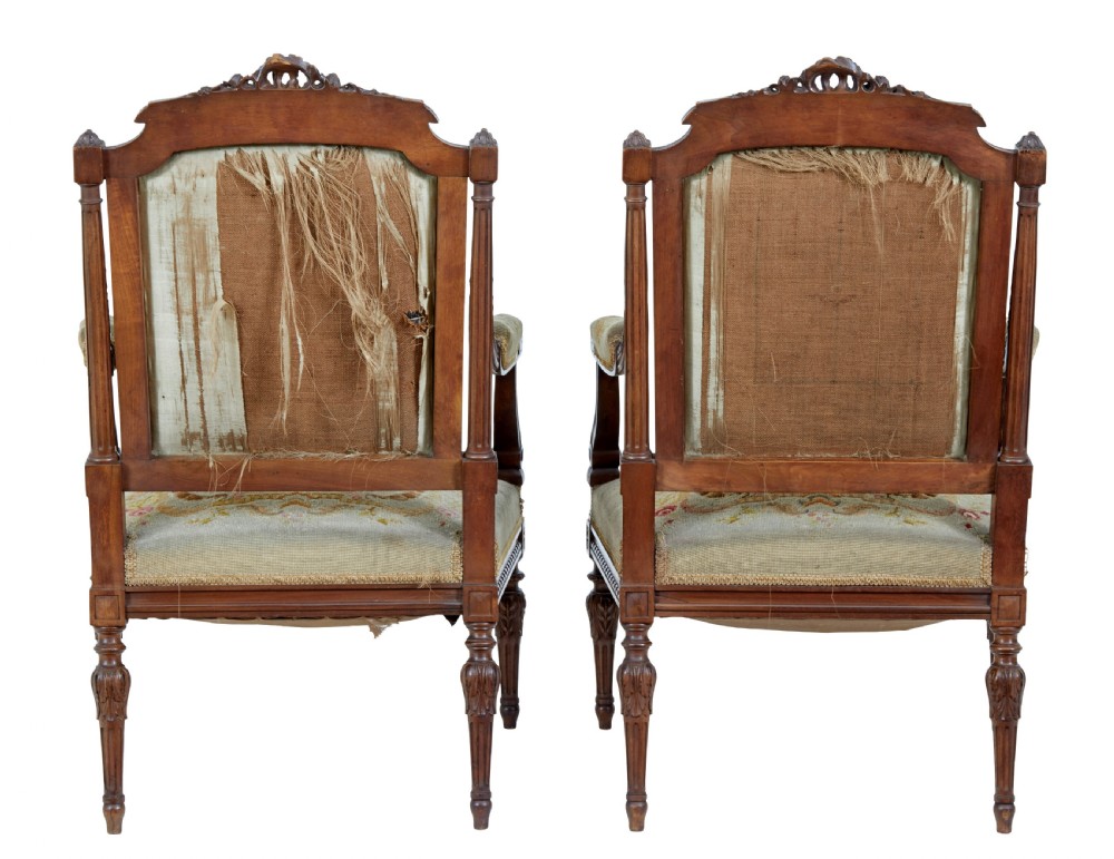 A pair of 19th-century French carved walnut armchairs upholstered in woven tapestry fabric featuring pastoral scenes and fluted turned legs. View IV