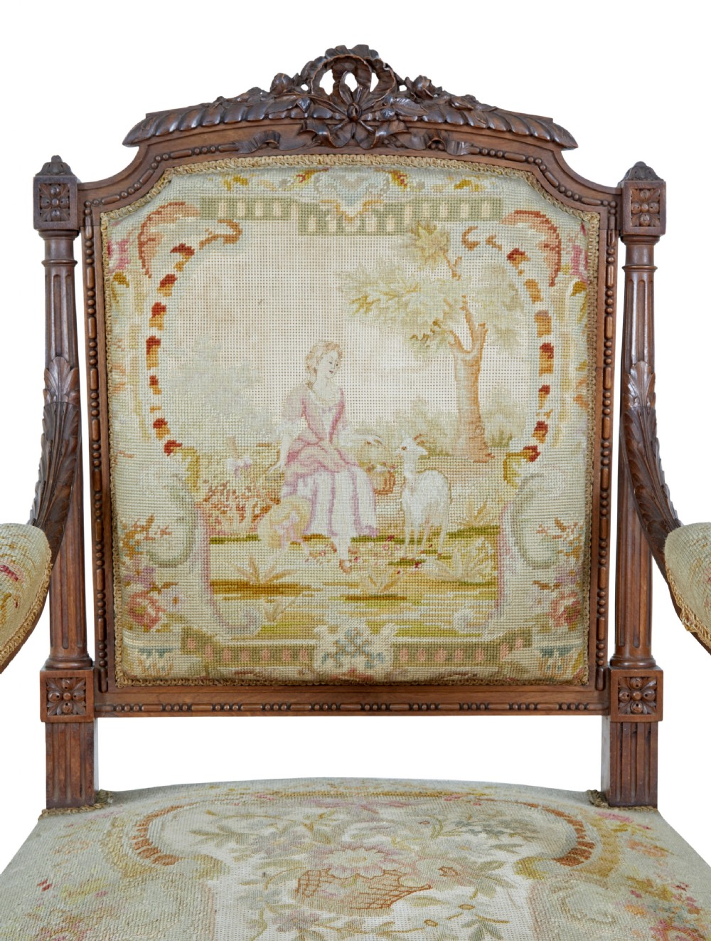 A pair of 19th-century French carved walnut armchairs upholstered in woven tapestry fabric featuring pastoral scenes and fluted turned legs. View V